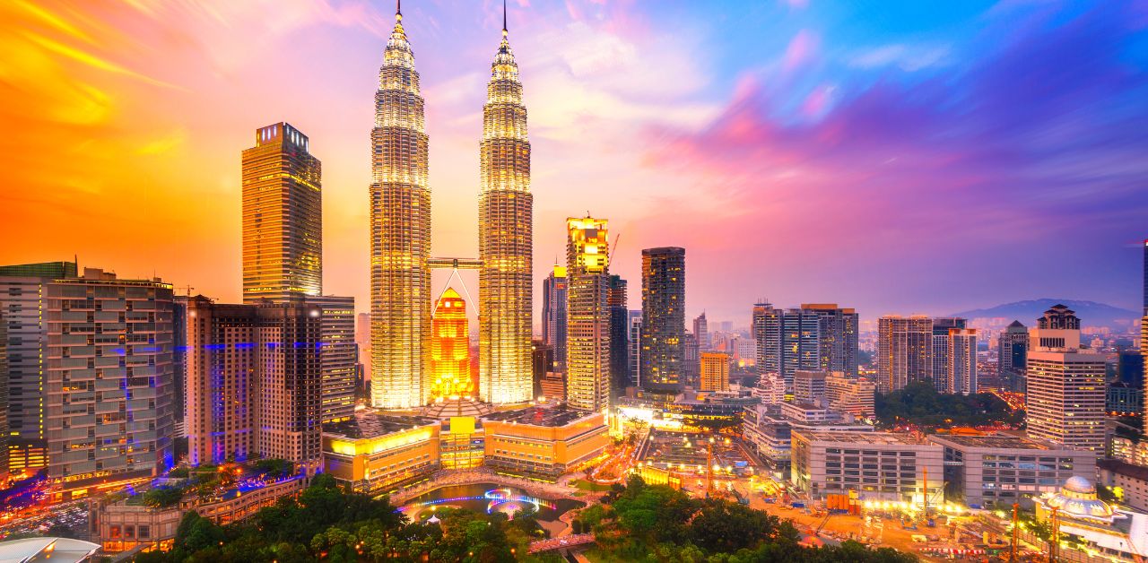 alt="travel Kuala Lumpur skyline at sunset, Malaysia vacation"